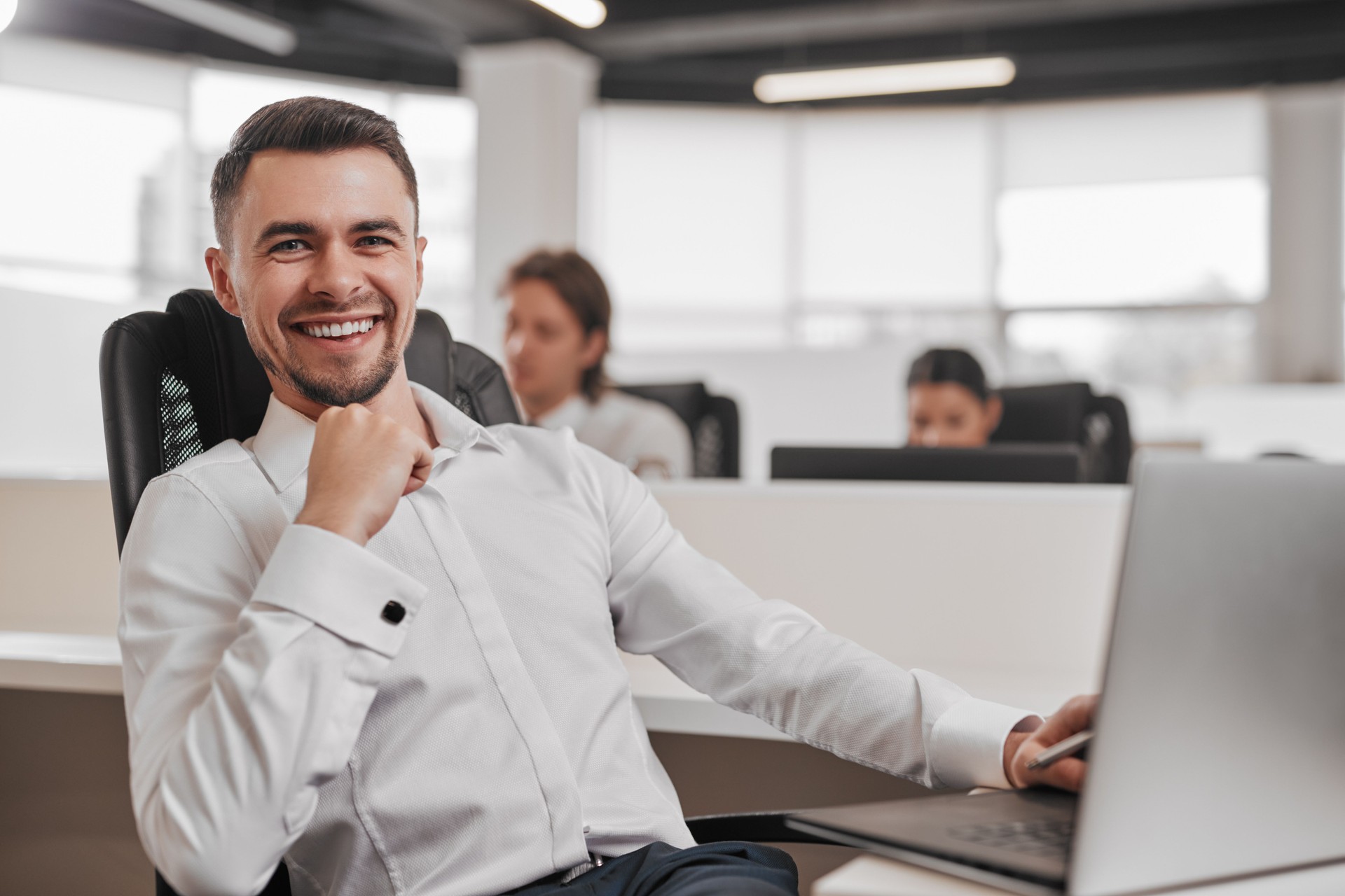 Happy male investor working in office